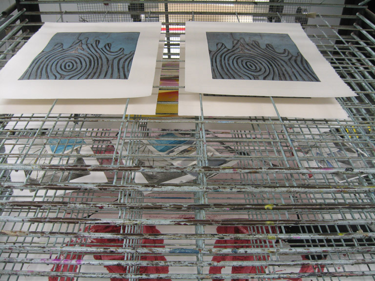 Prints drying in the rack.