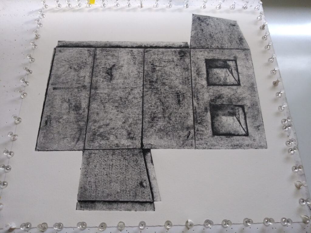 A photo of a pinned, drying collagraph impression.